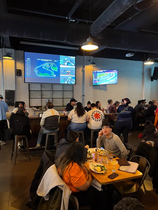 A daytime F1inTO room with the circuit map on the screens for the Sao Paulo Grand Prix