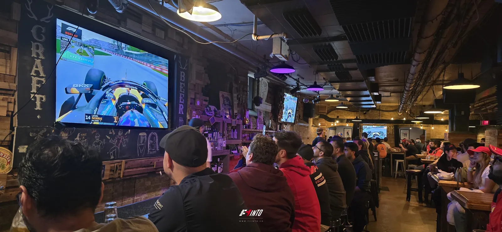 Canadian Grand Prix race day at F1inTO: the onboard on the big screen over a long bar of fans