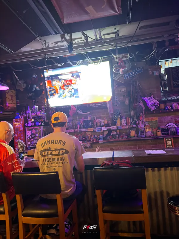 Fans on bar stools facing the screen at the Dutch Grand Prix