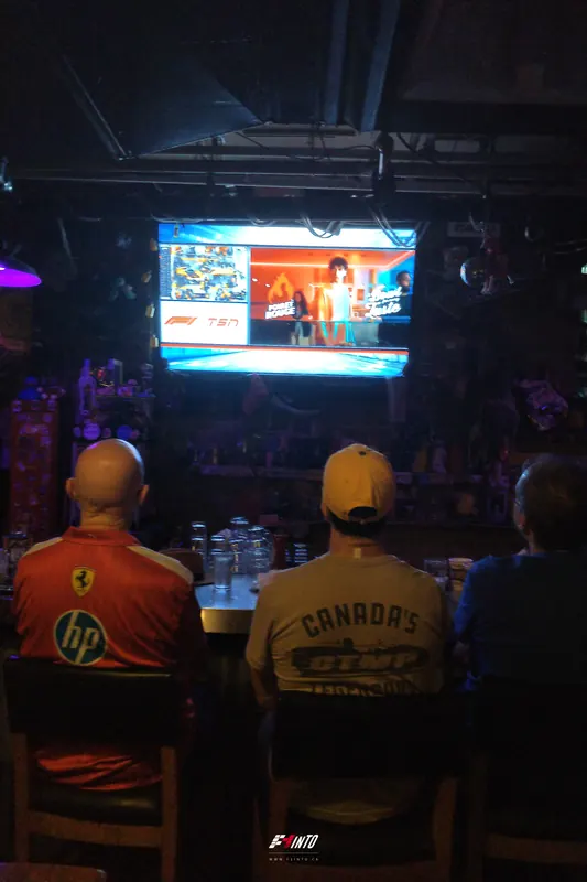 Two fans at the bar facing the screen at the Dutch Grand Prix