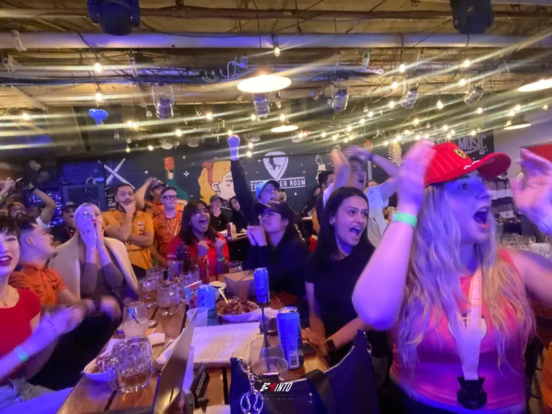 A table erupting at an overtake, the whole room behind them on its feet