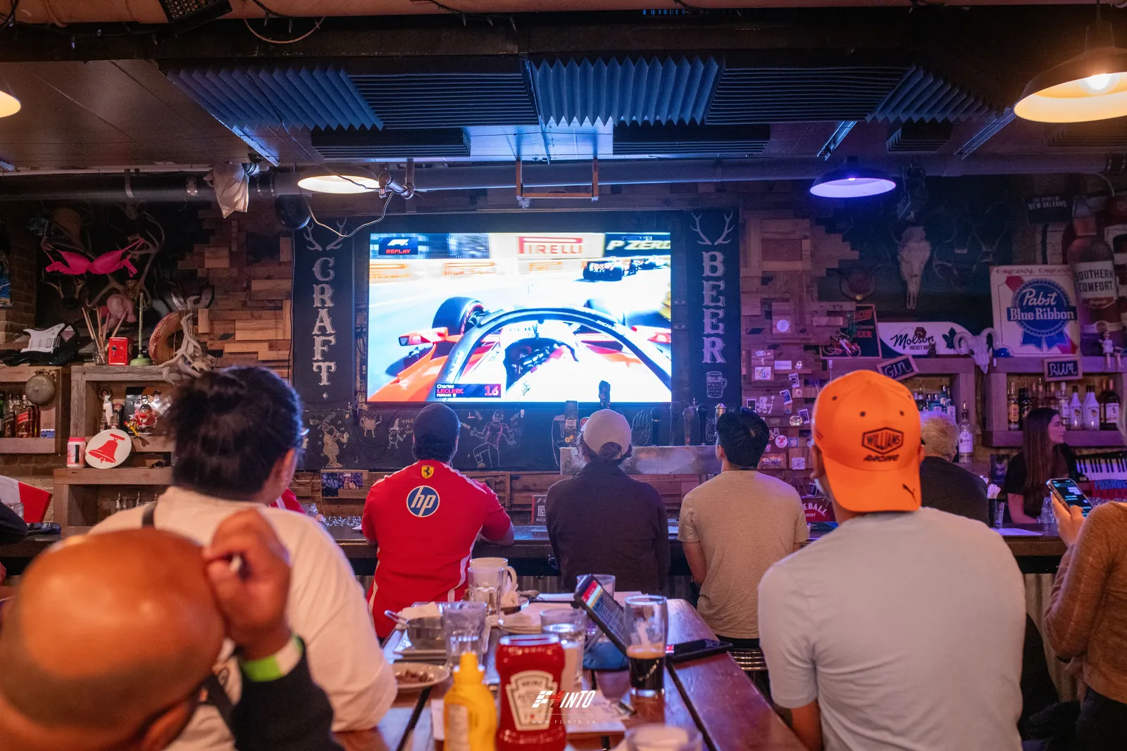 An F1inTO race day room watching the Monaco Grand Prix onboard on the big screen over the bar