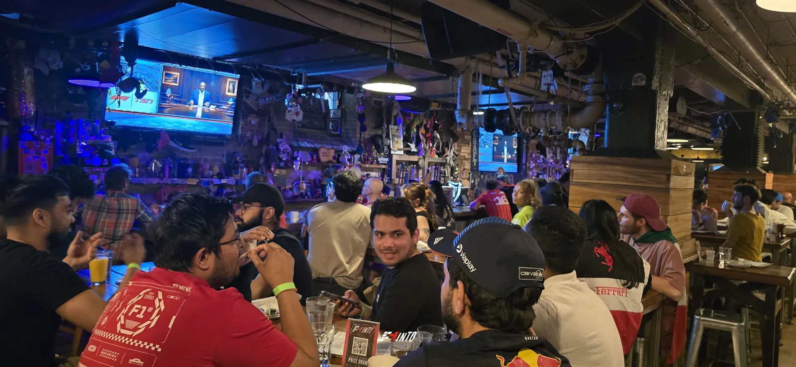 A packed F1inTO race day room facing the screens on Monaco Grand Prix day in Toronto