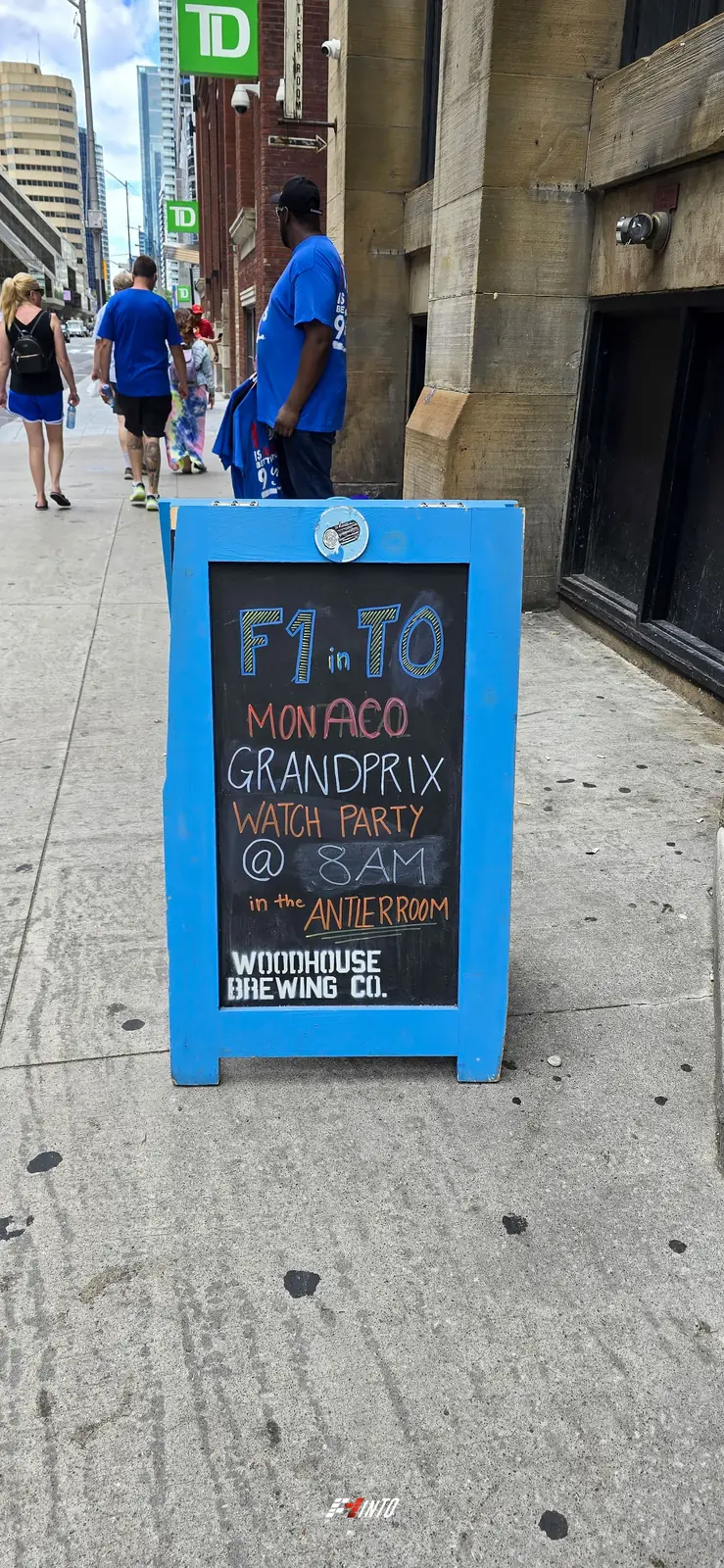 The F1inTO chalkboard sign on the sidewalk outside the venue, calling the Monaco Grand Prix watch party