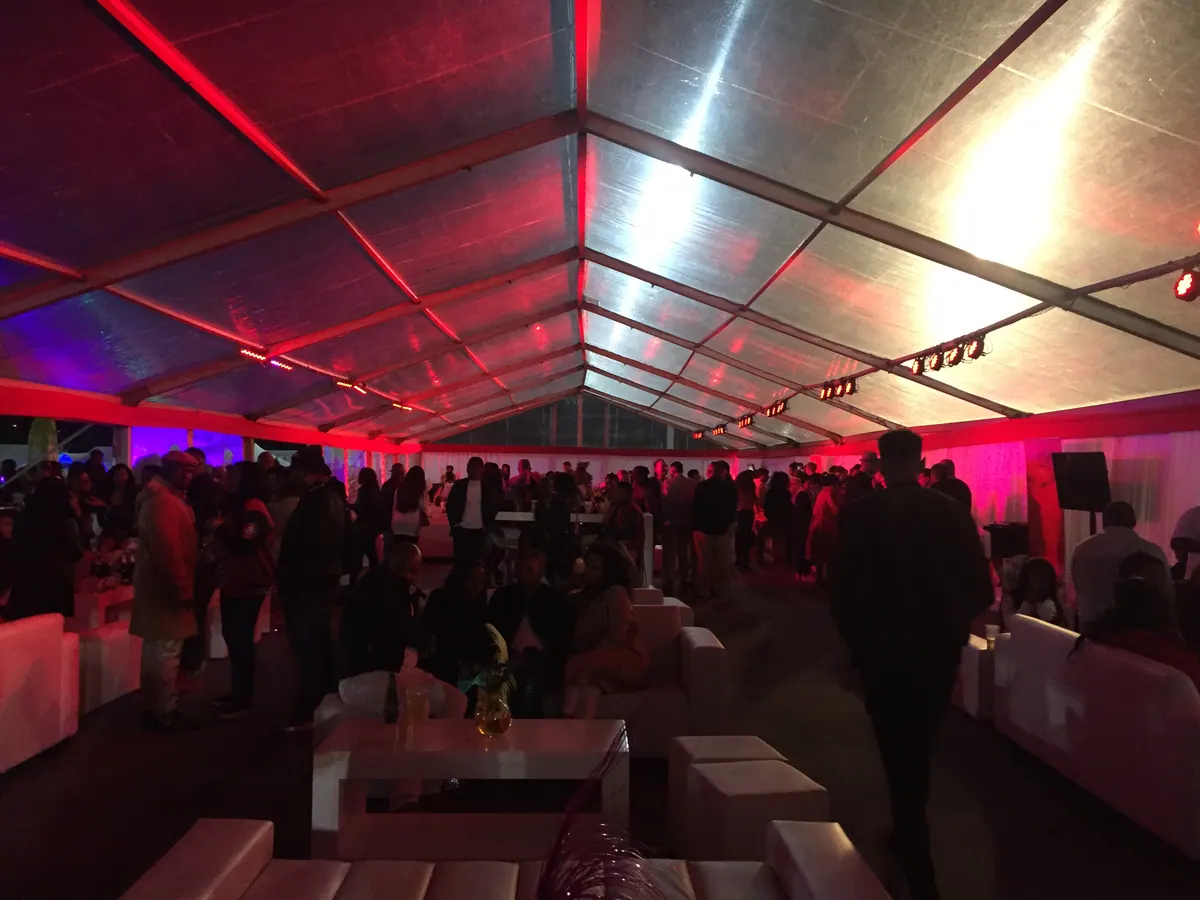 Guests inside a red-lit marquee at a Mabala Noise event
