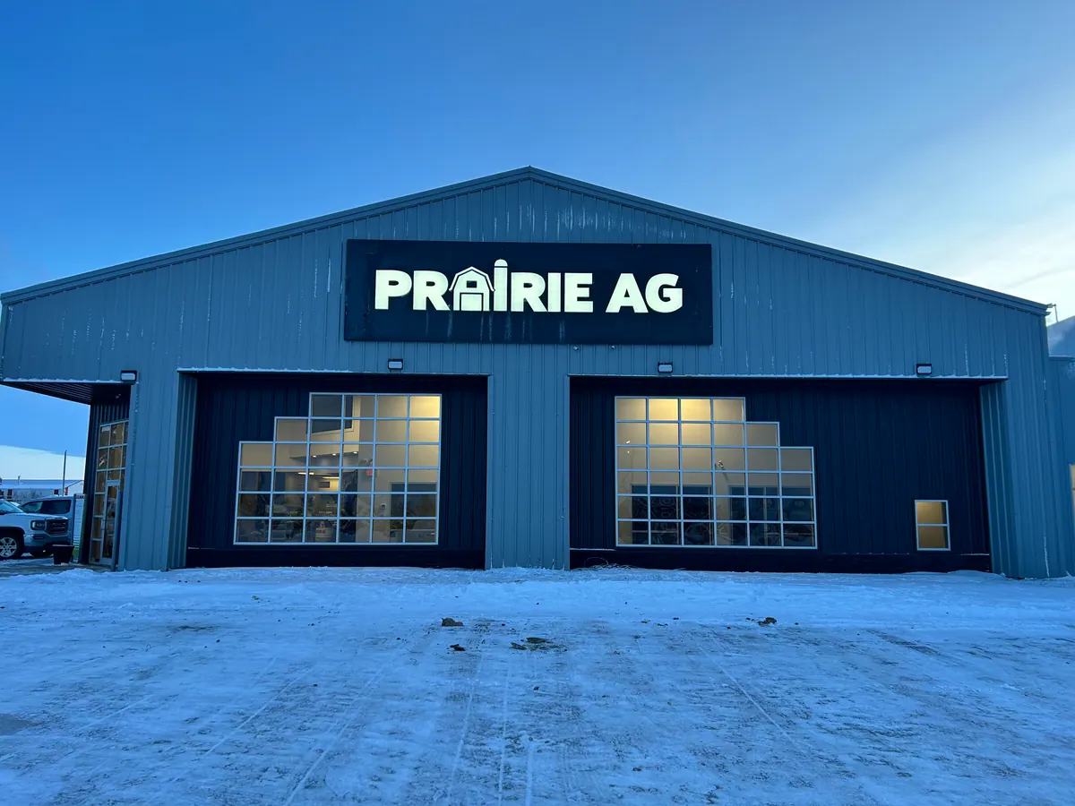 Prairie Ag signage on a blue dealership building in winter
