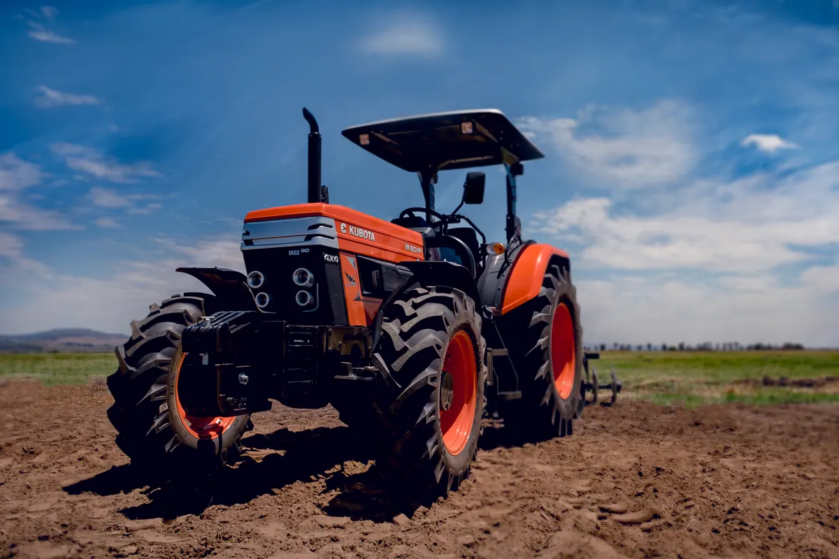 E-Kubota tractor photographed against a deep blue sky