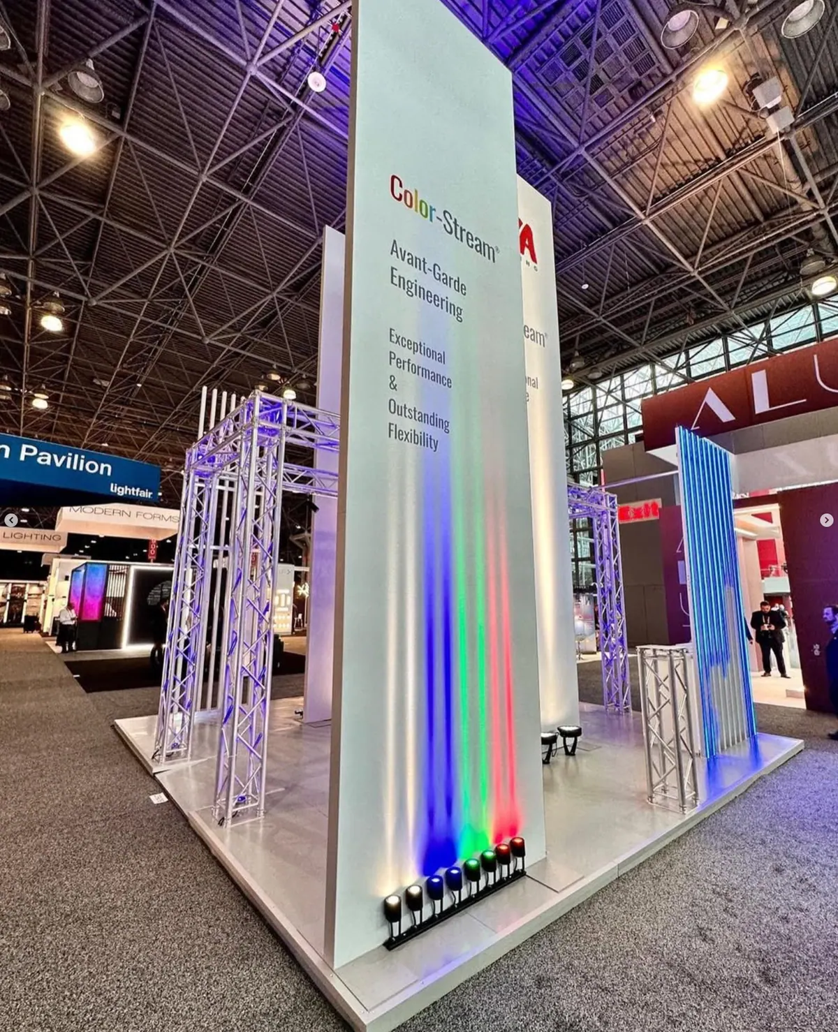 Corner of the GVA Lighting stand with Color-Stream signage and coloured uplighting