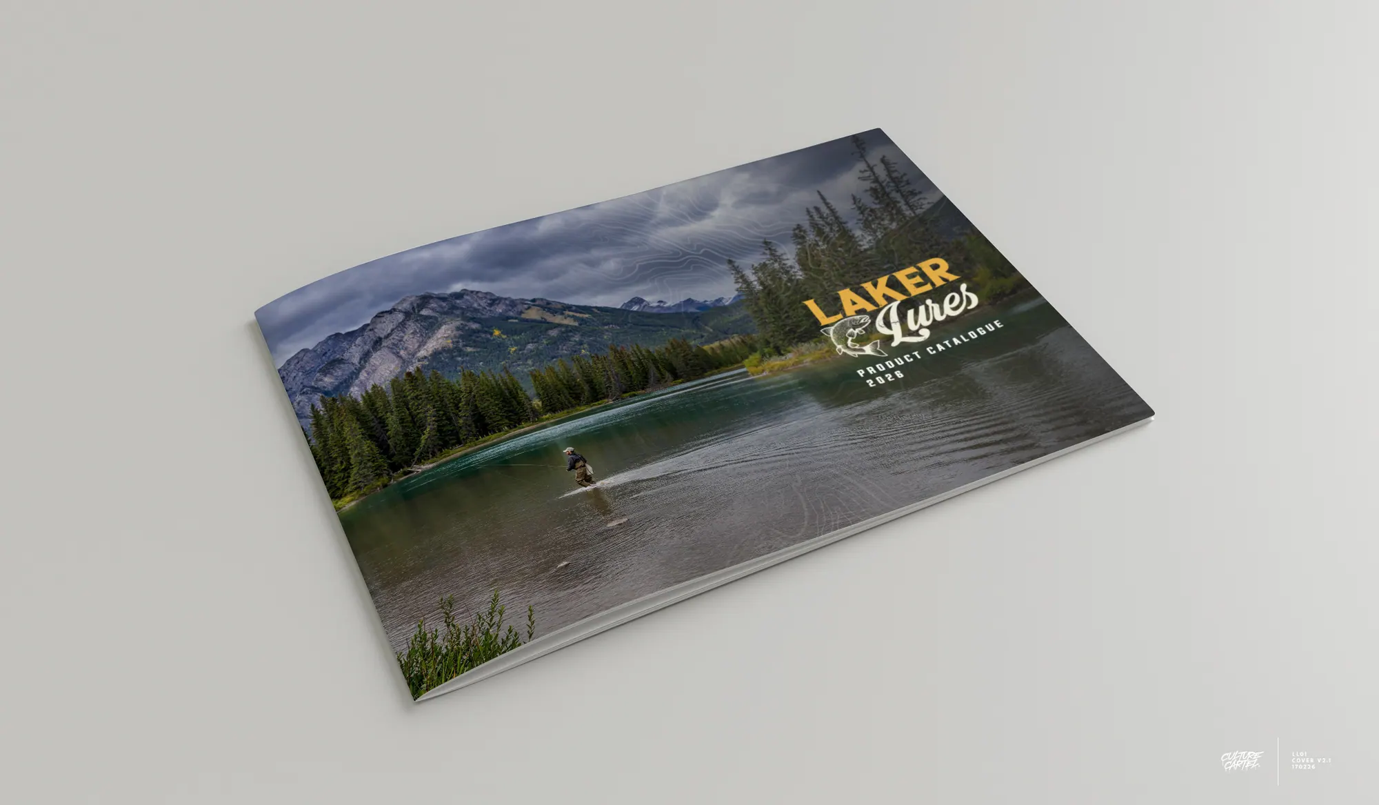 Laker Lures catalogue with a mountain lake cover photograph, lying open at an angle