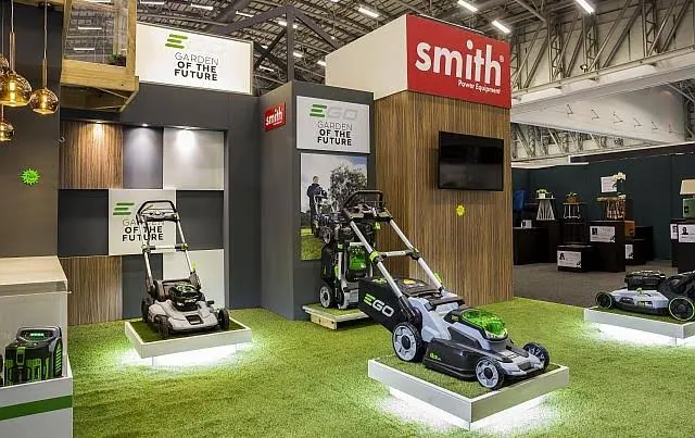 EGO battery lawnmowers on lit plinths at the Garden of the Future stand