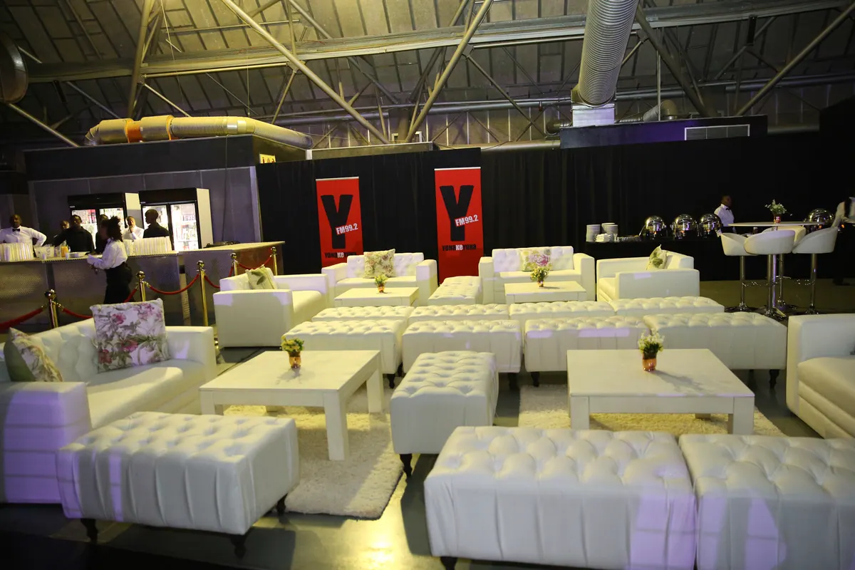 White VIP lounge seating set up inside an event venue