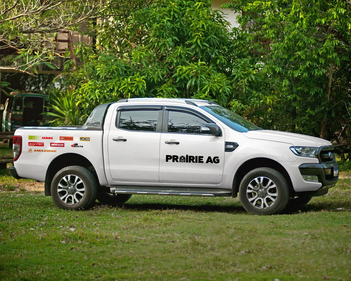 White pickup truck with Prairie Ag vehicle graphics