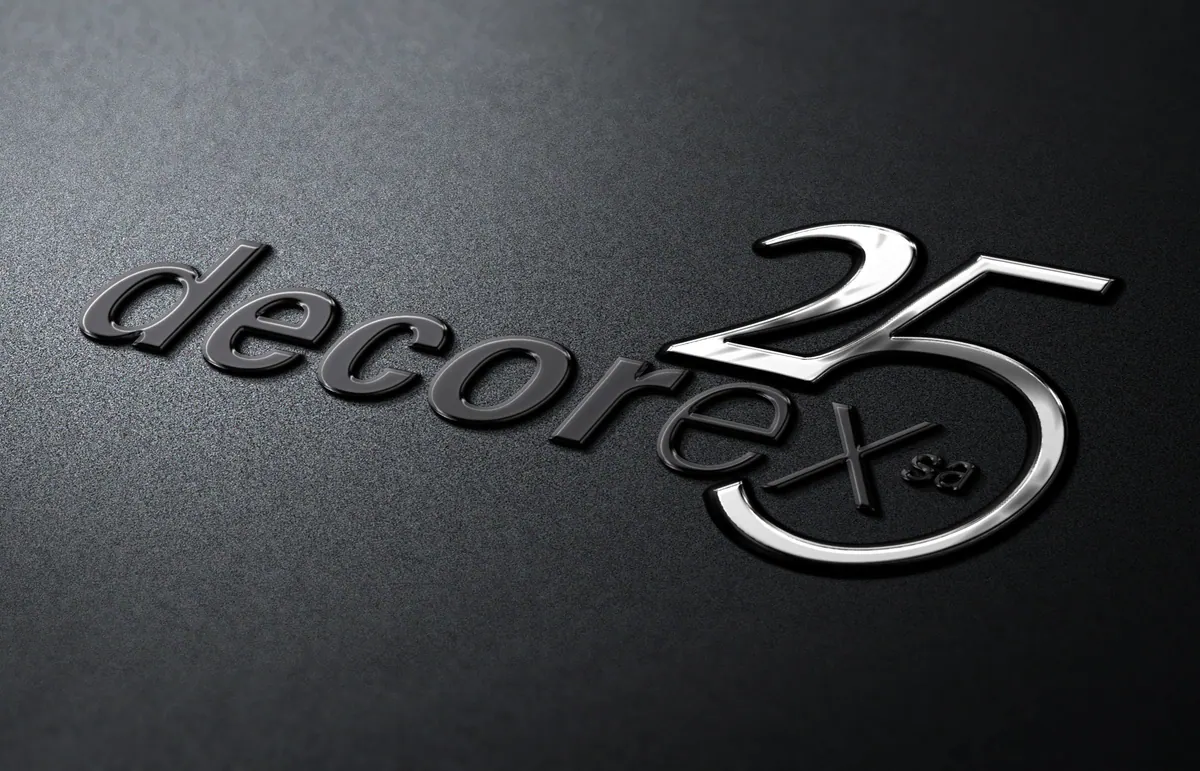 Decorex 25 anniversary logo as a metallic badge on dark textured card
