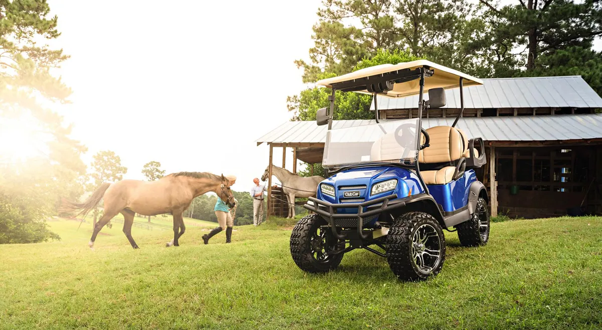 Club Car Onward four-passenger lifted vehicle in Pearl Blue on a horse farm