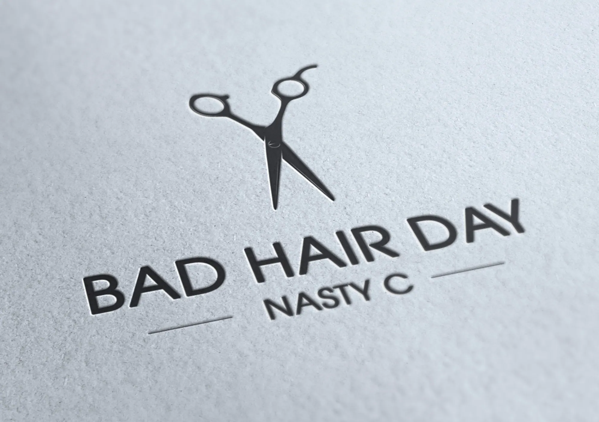Bad Hair Day scissors logo debossed on textured paper