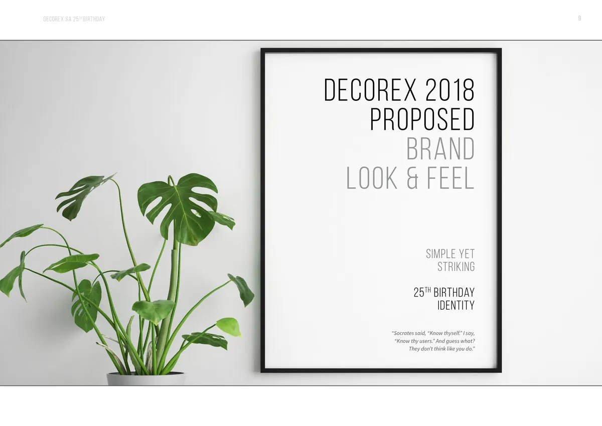 Framed poster of the proposed Decorex anniversary look and feel beside a plant