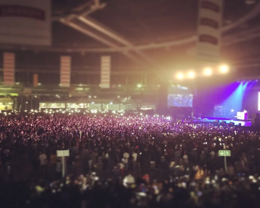 Packed crowd facing a lit stage at a Mabala Noise concert