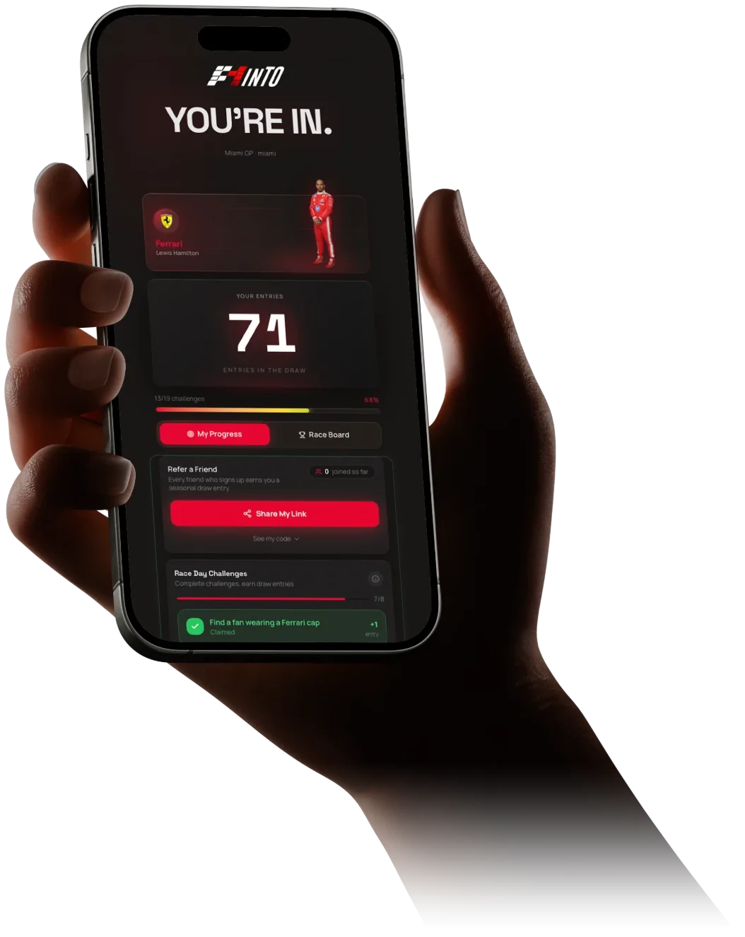 The F1inTO race-day app on a phone in a fan's hand: You're in, Ferrari picked, draw entries, refer a friend and race-day challenges