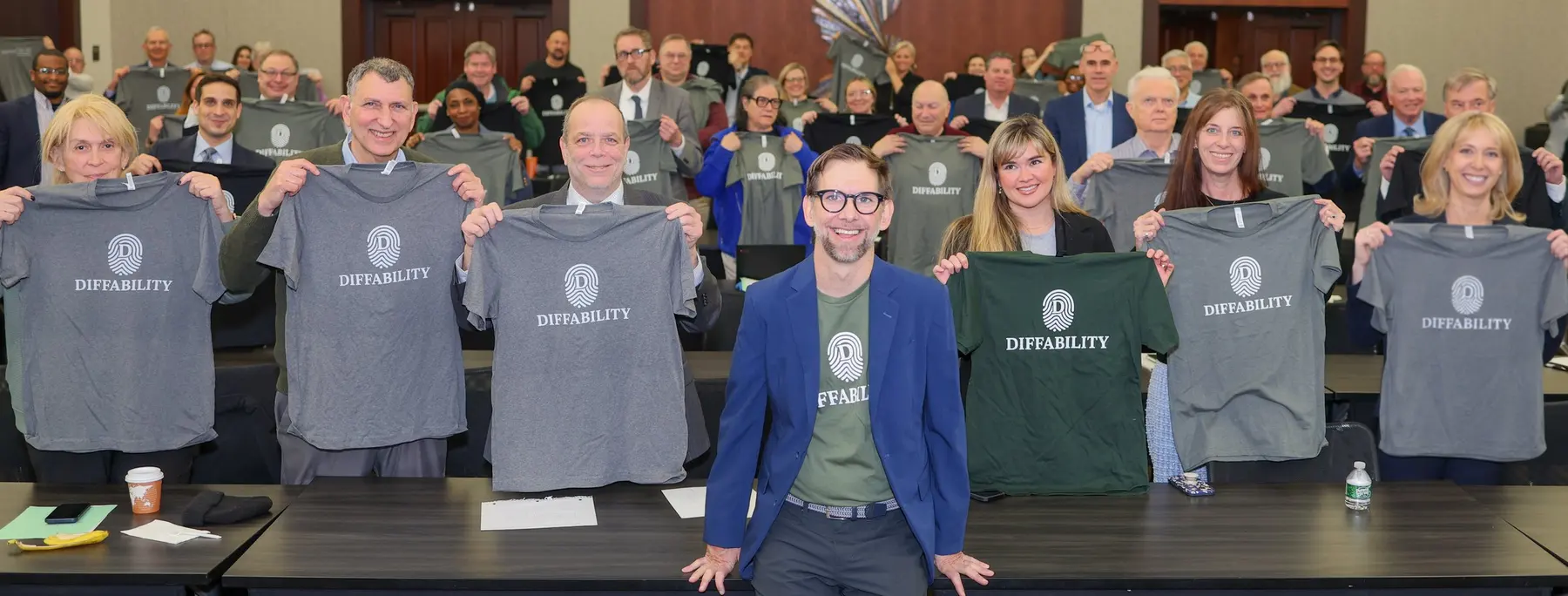 Michael Kutcher with a group in Diffability shirts, from his Rethink Difference work