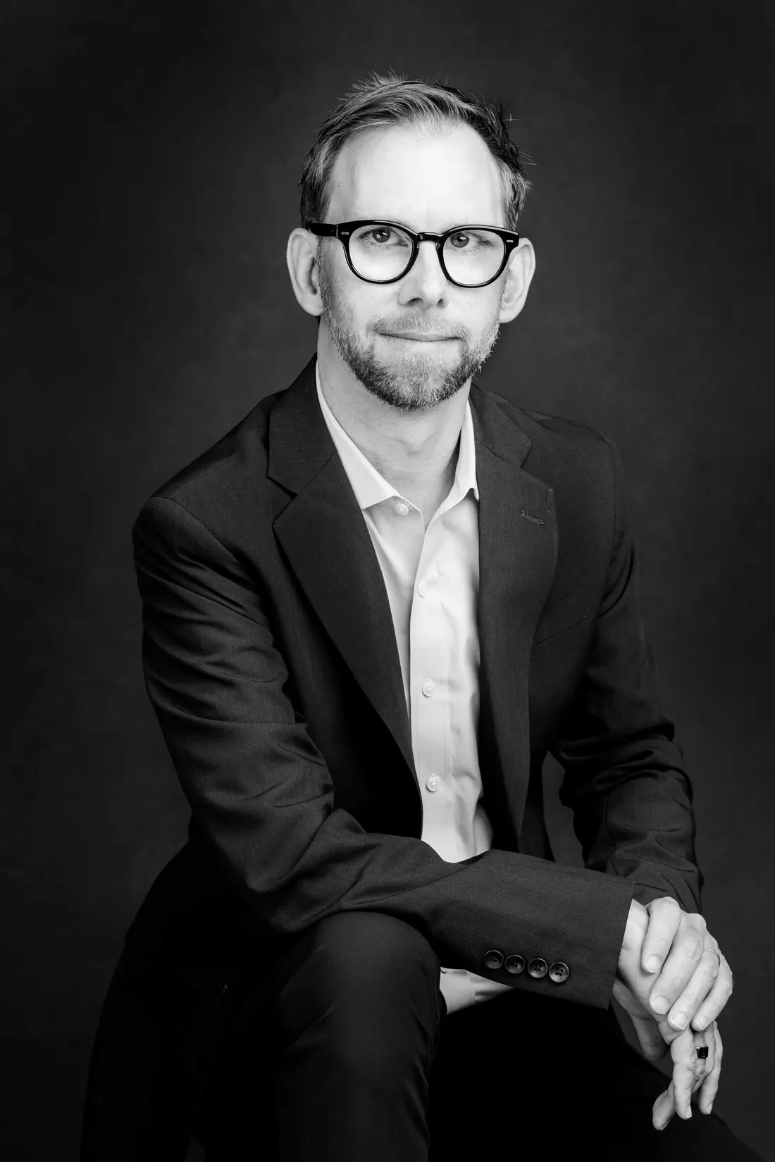 Black and white editorial portrait of Michael Kutcher